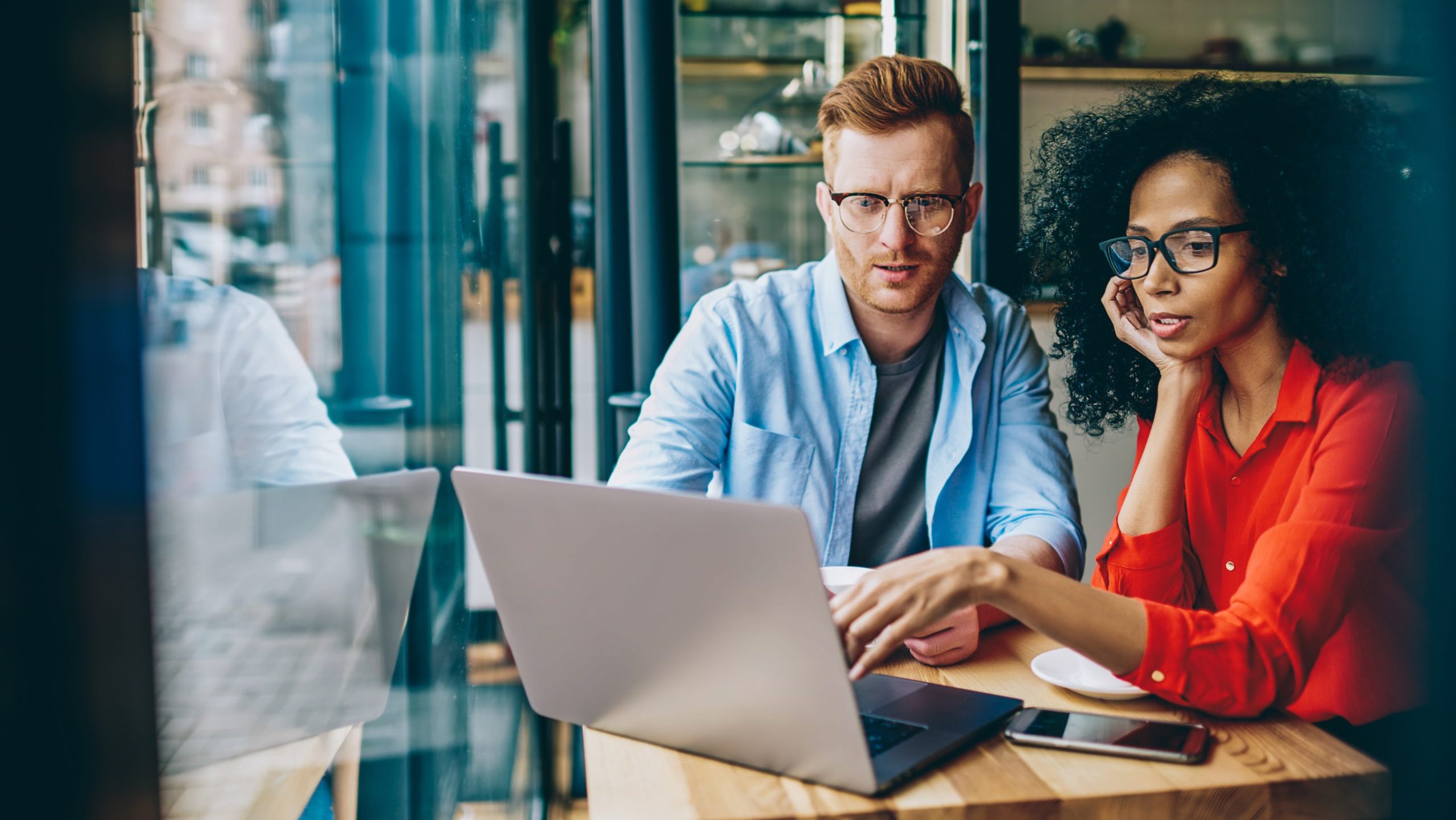 Two professionals working on a laptop while reviewing digital marketing strategies for improving Google rankings and SEO services in Melbourne.